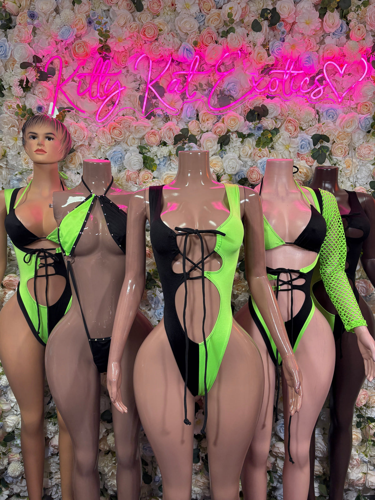 Group photo of neon green and black KittyKatExotics bottle girl bodysuits