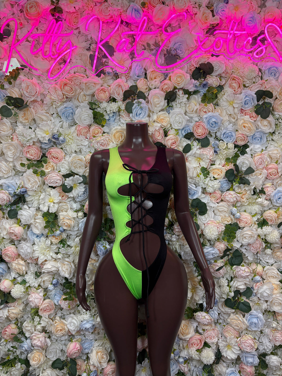 Neon green and black lace up cutout bodysuit front view