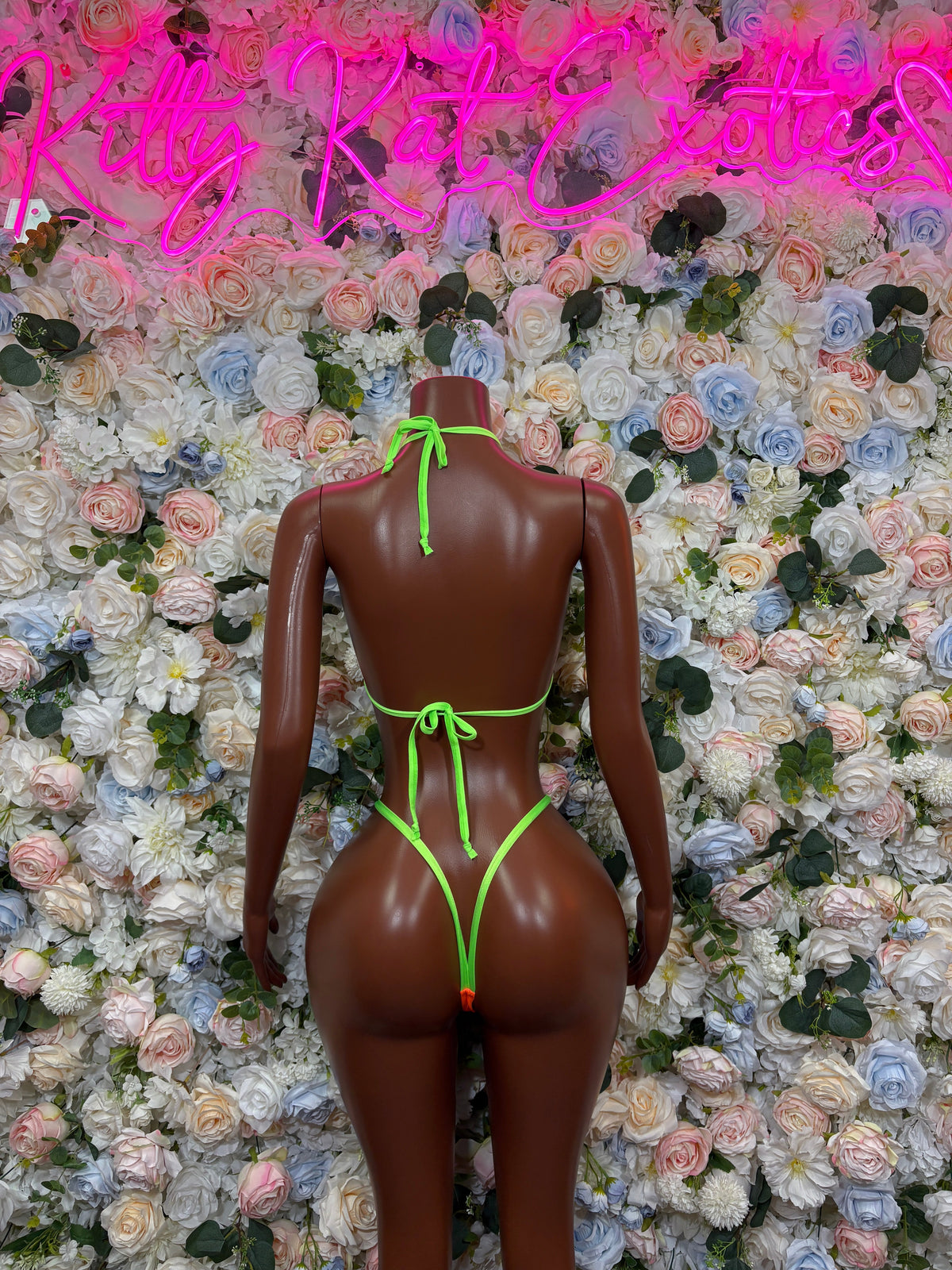 Orange triangle bikini set with neon green back straps, back view on mannequin