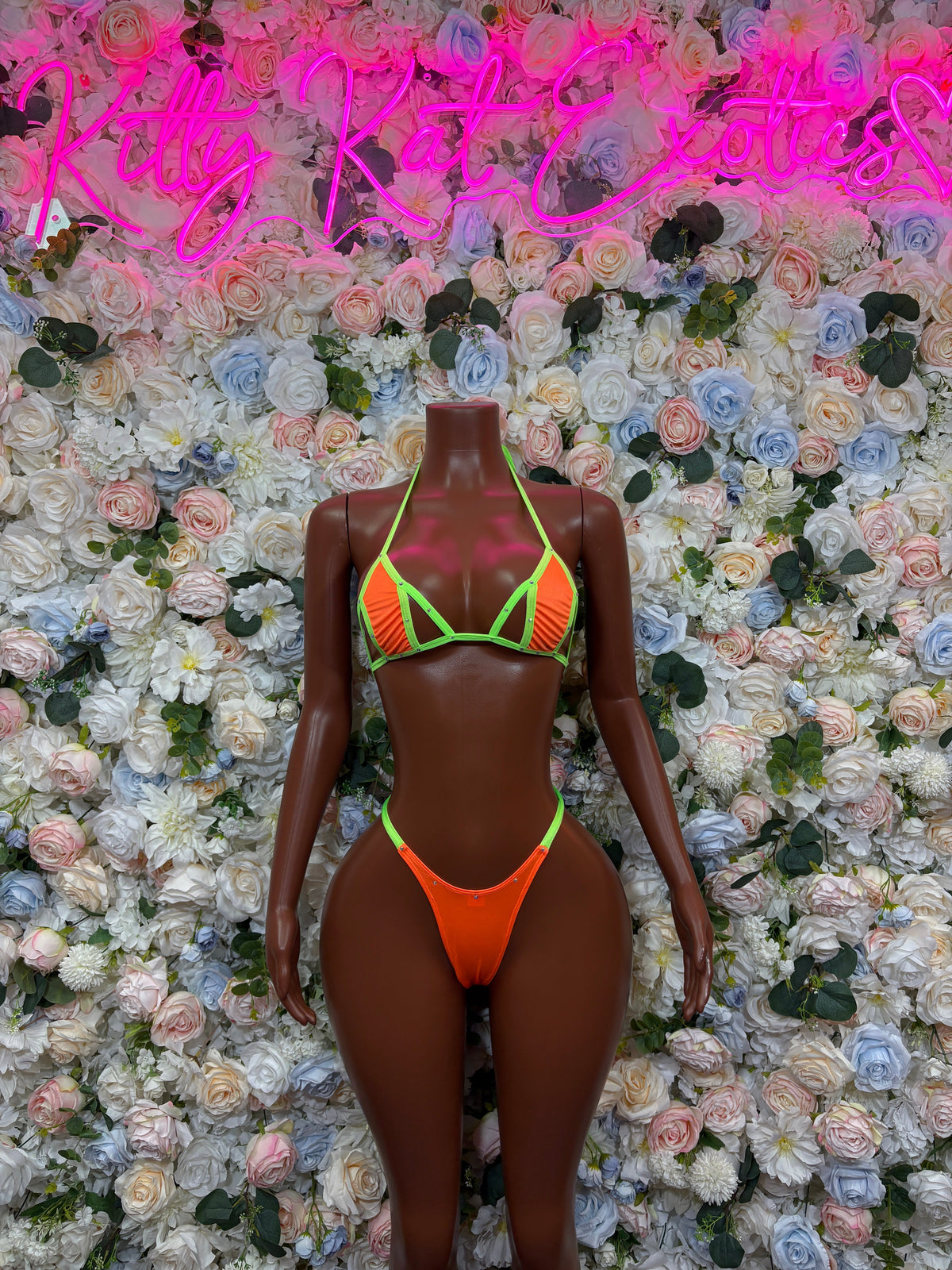 Orange triangle bikini set with neon green trim, front view on mannequin